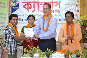 President of REHAB, Mukarram Hussain Khan, gives Certificates to the Trainees of Free Computer Training (Batch 128) as Chief Guest; Dr. M Helal is presiding over. (2014)